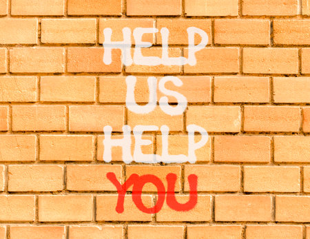 Help you symbol. Concept words phrase Help us help you on beautiful brown brick wall. Beautiful...