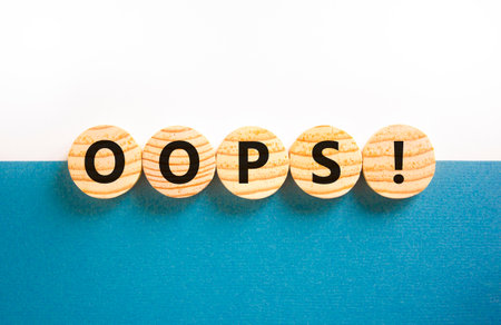 Oops symbol. Concept word Oops on beautiful wooden circles. Beautiful blue and white background. Business lifestyle oops concept. Copy space.の写真素材