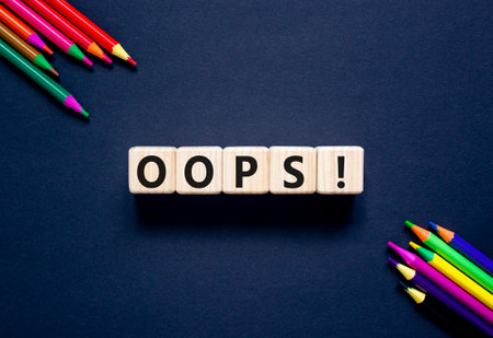 Oops symbol. Concept word Oops on beautiful wooden blocks. Beautiful black table black background. Beautiful colored pencils. Business lifestyle oops concept. Copy space.の写真素材
