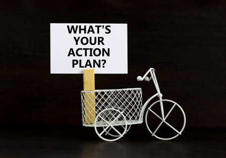 Action plan symbol. Concept words What is your action plan on beautiful white paper on clothespin. Beautiful black background. Miniature bicycle. Business What is your action plan concept. Copy space.の写真素材