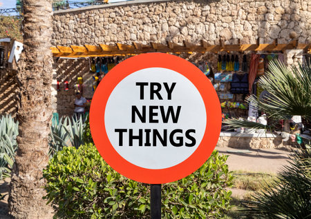 Try new things symbol. Concept words Try new things on beautiful big white road sign. Beautiful palm tree hotel market background. Business motivational lifestyle try new things concept. Copy space.の写真素材