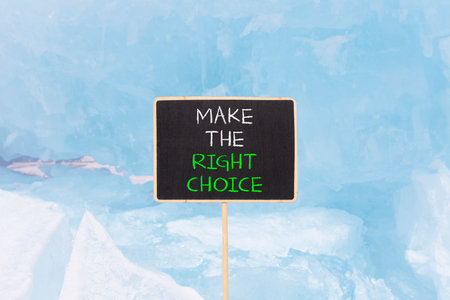 Make the right choice symbol. Concept words phrase Make the right choice on beautiful black blackboard. Beautiful blue ice background. Business Make the right choice concept. Copy space.の写真素材