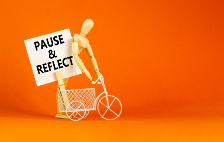 Pause and reflect symbol. Concept words Pause and reflect on beautiful white paper on clothespin. Beautiful orange background. Business motivational lifestyle pause and reflect concept. Copy space.の写真素材
