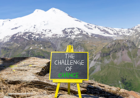 The challenge of chance symbol. Concept words phrase The challenge of chance on beautiful black blackboard. Beautiful mountain Elbrus background. Business The challenge of chance concept. Copy space.の写真素材