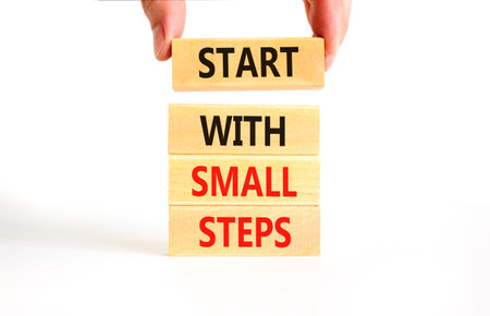 Start with small steps symbol. Concept words phrase Start with small steps on beautiful wooden...