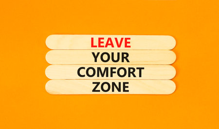 Leave your comfort zone symbol. Concept words Leave your comfort zone on beautiful wooden stick. Beautiful orange paper background. Business psychological Leave your comfort zone concept. Copy space.の写真素材