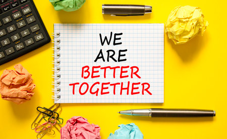 We are better together symbol. Concept words phrase We are better together on beautiful white note. Colored paper. Beautiful yellow background. Business We are better together concept. Copy spaceの写真素材
