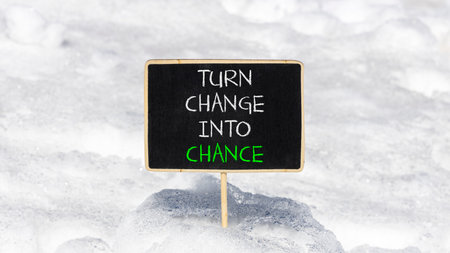 Turn change into chance symbol. Concept words phrase Turn change into chance on beautiful black blackboard. Beautiful white snow background. Business Turn change into chance concept. Copy space.の写真素材