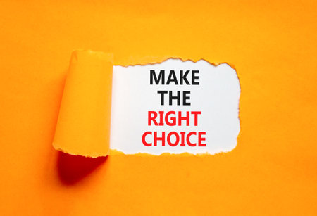Make the right choice symbol. Concept words phrase Make the right choice on beautiful white paper. Beautiful orange paper background. Business Make the right choice concept. Copy space.の写真素材