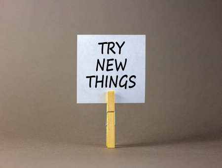Try new things symbol. Concept words Try new things on beautiful white paper on wooden clothespin. Beautiful gray background. Business motivational lifestyle try new things concept. Copy space.の写真素材