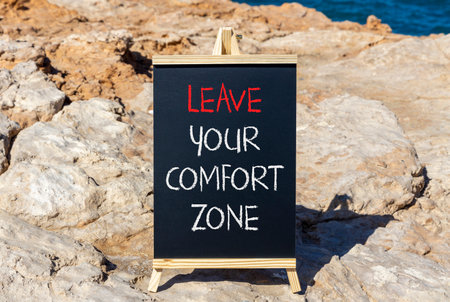 Leave your comfort zone symbol. Concept words Leave your comfort zone on beautiful black blackboard....