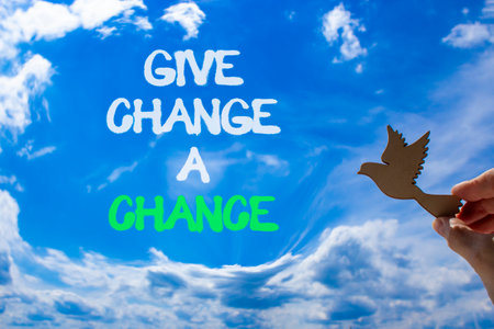 Give change a chance symbol. Concept words phrase Give change a chance on blue sky. Businessman's hand. Beautiful blue sky clouds background. Business Give change a chance concept. Copy space.の写真素材
