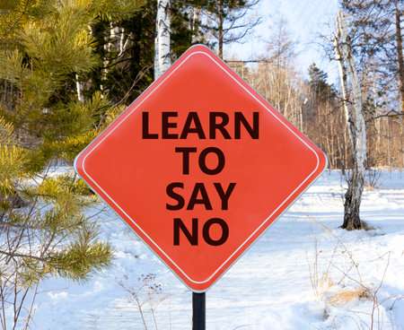 Learn to say no symbol. Concept words phrase Learn to say no on beautiful red road sign. Beautiful winter forest background. Business psychological Learn to say no concept. Copy space.の写真素材