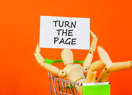 Turn the page symbol. Concept words Turn the page on beautiful white card. Beautiful orange background. Businessman model in shop cart. Business motivational lifestyle turn the page concept Copy spaceの写真素材