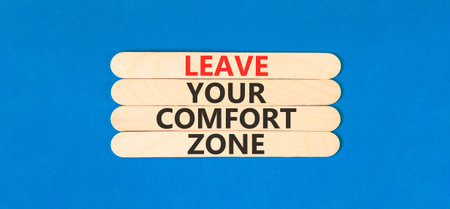 Leave your comfort zone symbol. Concept words Leave your comfort zone on beautiful wooden stick. Beautiful blue paper background. Business psychological Leave your comfort zone concept. Copy space.の写真素材