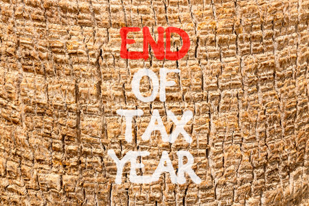 End of tax year symbol. Concept words phrase End of tax year on beautiful palm tree bark. Beautiful palm tree bark background. Business End of tax year concept. Copy space.の写真素材