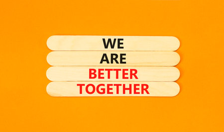 We are better together symbol. Concept words phrase We are better together on beautiful wooden stick. Beautiful orange paper background. Business We are better together concept. Copy space.の写真素材