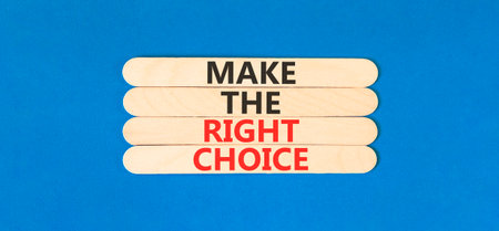 Make the right choice symbol. Concept words phrase Make the right choice on beautiful wooden stick. Beautiful blue paper background. Business Make the right choice concept. Copy space.の写真素材
