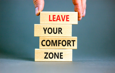Leave your comfort zone symbol. Concept words Leave your comfort zone on beautiful wooden blocks. Beautiful gray paper background. Business psychological Leave your comfort zone concept. Copy space.の写真素材