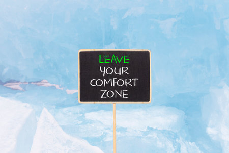 Leave your comfort zone symbol. Concept words Leave your comfort zone on beautiful black blackboard....