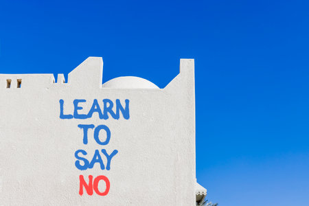 Learn to say no symbol. Concept words phrase Learn to say no on beautiful white wall. Beautiful white wall and blue sky background. Business psychological Learn to say no concept. Copy space.の写真素材