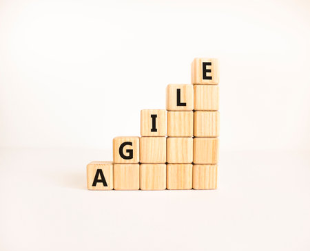 Agile symbol. Concept word Agile on beautiful wooden blocks. Beautiful white table white background. Business agile concept. Copy space.の写真素材