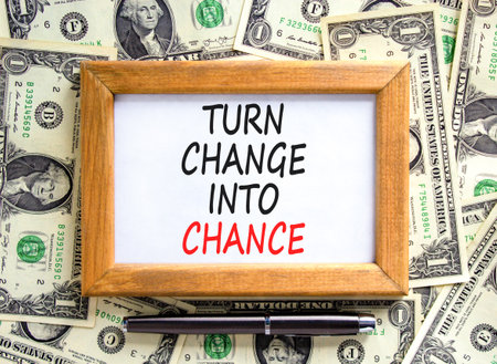 Turn change into chance symbol. Concept words phrase Turn change into chance on beautiful paper. Dollar bills. Beautiful dollar bills background. Business Turn change into chance concept. Copy space.の写真素材
