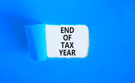 End of tax year symbol. Concept words phrase End of tax year on beautiful white paper. Beautiful...