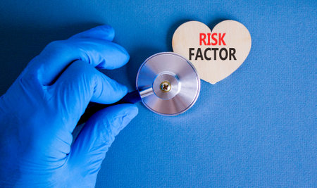 Risk factor symbol. Concept words Risk factor on beautiful wooden heart. Doctor's hand in blue medical glove. Stethoscope. Beautiful blue background. Medical healthy lifestyle risk factor concept.の写真素材