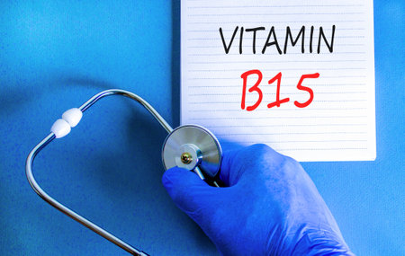 Vitamin B15 pantothenic acid symbol. Concept words Vitamin B15 on beautiful white note. Doctor's hand in blue medical glove. Beautiful blue background. Medical healthy lifestyle Vitamin B15 concept.の写真素材