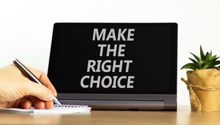 Make the right choice symbol. Concept words phrase Make the right choice on beautiful black tablet. Businessman's hand. Beautiful white background. Business Make the right choice concept. Copy space.の写真素材