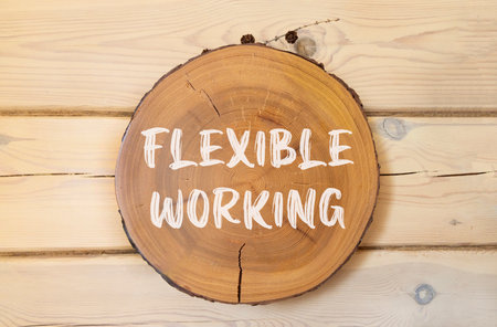 Flexible working symbol. Concept words Flexible working on beautiful wooden circle. Beautiful wooden wall background. Business flexible working concept. Copy space.の写真素材