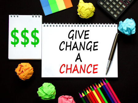 Give change a chance symbol. Concept words phrase Give change a chance on beautiful white note. Colored paper Calculator Beautiful black background. Business Give change a chance concept. Copy space.の写真素材