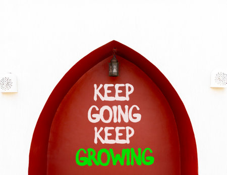 Keep going and growing symbol. Concept words phrase Keep going keep growing on beautiful brown wall. Beautiful white wall background. Business Keep going and growing concept. Copy space.の写真素材