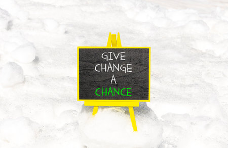 Give change a chance symbol. Concept words phrase Give change a chance on beautiful black blackboard. Beautiful white snow background. Business Give change a chance concept. Copy space.の写真素材