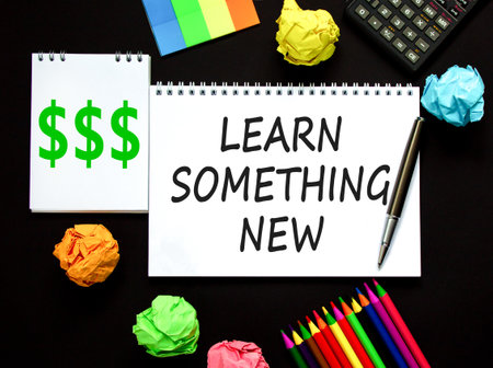 Learn something new symbol. Concept words Learn something new on beautiful white note. Calculator. Beautiful black background. Business motivational lifestyle learn something new concept. Copy space.の写真素材