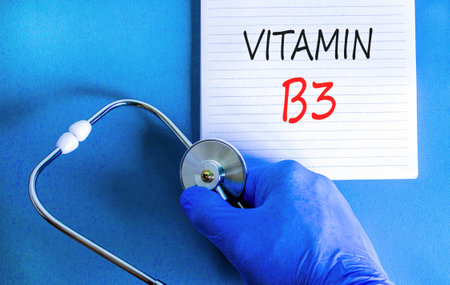 Vitamin B3 niacin symbol. Concept words Vitamin B3 on beautiful white note. Doctor's hand in blue medical glove. Beautiful blue background. Medical healthy lifestyle Vitamin B3 niacin concept.の写真素材