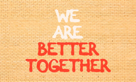 We are better together symbol. Concept words phrase We are better together on beautiful brown brick wall. Beautiful brown brick wall background. Business We are better together concept. Copy space.の写真素材