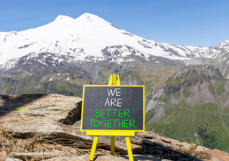 We are better together symbol. Concept words phrase We are better together on beautiful black blackboard. Beautiful mountain Elbrus background. Business We are better together concept. Copy space.の写真素材
