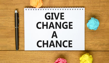 Give change a chance symbol. Concept words phrase Give change a chance on beautiful white note. Colored paper. Beautiful wooden background. Business Give change a chance concept. Copy space.の写真素材