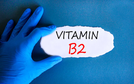 Vitamin B2 riboflavin symbol. Concept words Vitamin B2 on beautiful white paper. Doctor's hand in...