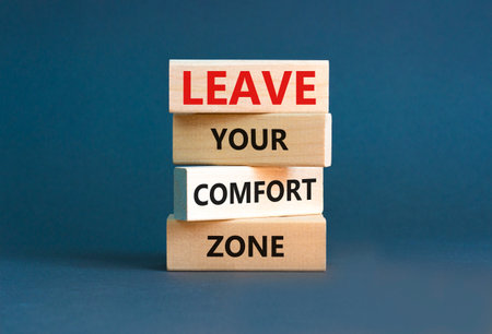 Leave your comfort zone symbol. Concept words Leave your comfort zone on beautiful wooden blocks. Beautiful gray paper background. Business psychological Leave your comfort zone concept. Copy space.の写真素材