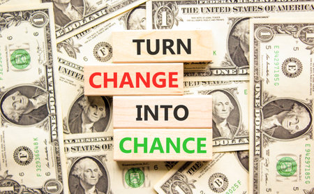 Turn change into chance symbol. Concept words phrase Turn change into chance on beautiful blocks. Dollar bills. Beautiful dollar bills background. Business Turn change into chance concept. Copy space.の写真素材