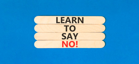 Learn to say no symbol. Concept words phrase Learn to say no on beautiful wooden stick. Beautiful blue paper background. Business psychological Learn to say no concept. Copy space.の写真素材