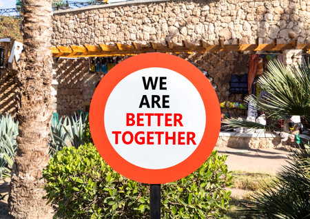 We are better together symbol. Concept words phrase We are better together on beautiful road sign. Beautiful palm tree background. Business We are better together concept. Copy space.の写真素材