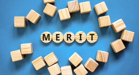 Merit symbol. Concept word Merit on beautiful wooden circles. Beautiful blue table blue background. Beautiful wooden cubes. Business lifestyle merit concept. Copy space.の写真素材