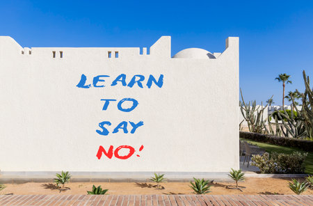 Learn to say no symbol. Concept words phrase Learn to say no on beautiful white wall. Beautiful white wall and blue sky background. Business psychological Learn to say no concept. Copy space.の写真素材