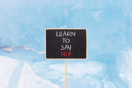 Learn to say no symbol. Concept words phrase Learn to say no on beautiful black blackboard. Beautiful blue ice background. Business psychological Learn to say no concept. Copy space.の写真素材