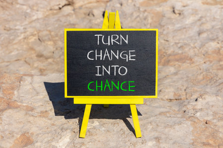 Turn change into chance symbol. Concept words phrase Turn change into chance on beautiful black blackboard. Beautiful stone background. Business Turn change into chance concept. Copy space.の写真素材
