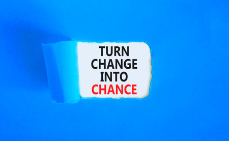 Turn change into chance symbol. Concept words phrase Turn change into chance on beautiful white paper. Beautiful blue paper background. Business Turn change into chance concept. Copy space.の写真素材